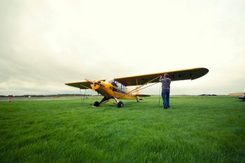 Brian O'Keeffe untying Howard Cox's Piper Cub G-BJEI. Photo by Neil Sheehan.