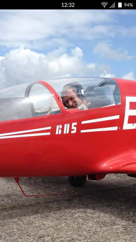 This picture perfectly captures Howard's famous smile through the storm window of his BD5.